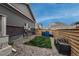 Small backyard area with a patch of grass, stone ground cover, and wood fence at 17614 Cherokee St, Broomfield, CO 80023