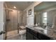 Modern bathroom showcasing granite countertop, glass enclosed shower, and stylish fixtures at 17614 Cherokee St, Broomfield, CO 80023
