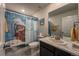 Fun bathroom design featuring shower with decorative cat shower curtain and bright colors at 17614 Cherokee St, Broomfield, CO 80023