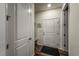 Bright entryway with white doors, mudroom bench, coat hooks, and dark floors at 17614 Cherokee St, Broomfield, CO 80023