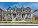 Attractive exterior view of townhomes with welcoming front porches and manicured lawns at 17614 Cherokee St, Broomfield, CO 80023