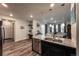 Modern kitchen with stainless appliances and island seating area flows into living areas at 17614 Cherokee St, Broomfield, CO 80023