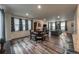 Open-concept living and dining area with wood floors, neutral paint, and bright natural light at 17614 Cherokee St, Broomfield, CO 80023