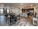 Open-concept living and dining area flows into a modern kitchen with stainless appliances at 17614 Cherokee St, Broomfield, CO 80023