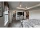 Bright main bedroom with a decorative tray ceiling leading to the bathroom and hallway at 17614 Cherokee St, Broomfield, CO 80023