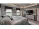 Spacious main bedroom featuring neutral colors, tray ceiling, and large windows at 17614 Cherokee St, Broomfield, CO 80023