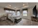 Elegant main bedroom featuring tray ceiling, ample natural light, and stylish furnishings at 17614 Cherokee St, Broomfield, CO 80023