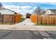 View of the back driveway, featuring an enclosed driveway and open wooden fence at 12116 N Fairfax St, Thornton, CO 80241