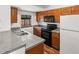 Bright kitchen featuring stone countertops and modern appliances at 12116 N Fairfax St, Thornton, CO 80241