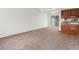 Neutral living room featuring neutral carpet, built-in shelving, and natural light at 12116 N Fairfax St, Thornton, CO 80241