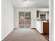 Spacious living room with sliding door leading to the backyard and adjoined with a kitchen at 12116 N Fairfax St, Thornton, CO 80241