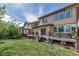 A beautiful backyard featuring a spacious deck, a hot tub, and lush green grass at 21658 E Tallkid Ave, Parker, CO 80138