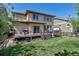 Landscaped backyard features well-maintained lawn, back deck, mature trees providing privacy and shade at 21658 E Tallkid Ave, Parker, CO 80138