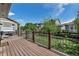 Backyard deck view with railing overlooking a landscaped yard and houses in the neighborhood at 21658 E Tallkid Ave, Parker, CO 80138