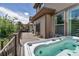 Backyard deck with a hot tub and barbeque grill, overlooking a landscaped backyard at 21658 E Tallkid Ave, Parker, CO 80138