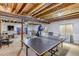 Basement room featuring a ping pong table, exercise equipment, and bar table with chairs at 21658 E Tallkid Ave, Parker, CO 80138