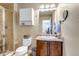 Bathroom featuring tile shower, vanity with a single sink, and a white medicine cabinet at 21658 E Tallkid Ave, Parker, CO 80138