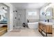 Light and bright bathroom featuring a glass shower and double sink vanity at 21658 E Tallkid Ave, Parker, CO 80138