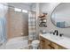 Bathroom features a shower/tub combo, decorative tile floors and a wood vanity at 21658 E Tallkid Ave, Parker, CO 80138