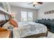 Cozy bedroom featuring a dark wood bed frame, a ceiling fan, and plantation shutters at 21658 E Tallkid Ave, Parker, CO 80138