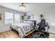 Comfortable bedroom featuring a ceiling fan, a window with shutters, and a desk area at 21658 E Tallkid Ave, Parker, CO 80138