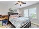 Bedroom boasting hardwood floors, a ceiling fan, plantation shutters, and a bed with storage at 21658 E Tallkid Ave, Parker, CO 80138