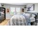 Bedroom featuring a bed with striped bedding, shutters, and artwork at 21658 E Tallkid Ave, Parker, CO 80138