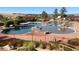 Resort-style community pool featuring ample lounge space, wading areas, and covered seating, perfect for summer enjoyment at 21658 E Tallkid Ave, Parker, CO 80138