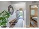 Inviting foyer featuring a decorative mirror, bench seating, and a view into the home at 21658 E Tallkid Ave, Parker, CO 80138