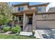 Inviting home with a covered front porch and well-maintained landscaping at 21658 E Tallkid Ave, Parker, CO 80138