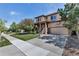 Charming two-story home with a well-manicured lawn and a spacious driveway at 21658 E Tallkid Ave, Parker, CO 80138