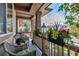 Charming covered front porch with wicker furniture, potted plants, and decorative accents for relaxation at 21658 E Tallkid Ave, Parker, CO 80138