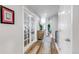 Hallway with hardwood floors leading to an office, and an upper level space at 21658 E Tallkid Ave, Parker, CO 80138