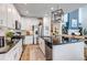 Open concept kitchen with a large island, stainless steel appliances and custom cabinets at 21658 E Tallkid Ave, Parker, CO 80138