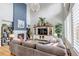 Spacious living room with a fireplace, and an open layout connecting to the kitchen and dining area at 21658 E Tallkid Ave, Parker, CO 80138