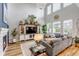 Open-concept living area with high ceilings, modern lighting, and a large comfortable sofa at 21658 E Tallkid Ave, Parker, CO 80138