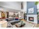 Open-concept living room with a fireplace, and open access to the kitchen and dining area at 21658 E Tallkid Ave, Parker, CO 80138