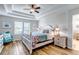 Beautiful bedroom with tray ceiling, ceiling fan and ensuite bath at 21658 E Tallkid Ave, Parker, CO 80138