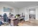 Bright office featuring a wooden desk, hardwood floors, and glass doors at 21658 E Tallkid Ave, Parker, CO 80138