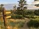 Picturesque walking trail with signage, winding through natural landscape with lush greenery at 21658 E Tallkid Ave, Parker, CO 80138