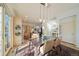 Bright dining area with a wooden table, adjacent to the kitchen at 7777 E 1St Pl # 110, Denver, CO 80230