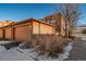 Attached garage and building exterior with landscaping at 7777 E 1St Pl # 110, Denver, CO 80230