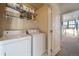 Bright laundry room with washer, dryer, and shelving at 7777 E 1St Pl # 110, Denver, CO 80230