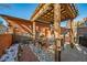 Private patio with pergola, seating area, and outdoor grill at 7777 E 1St Pl # 110, Denver, CO 80230