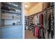 Large walk-in closet with ample shelving and hanging space for clothes and shoes at 7777 E 1St Pl # 110, Denver, CO 80230