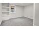 Bright bedroom featuring neutral carpet, closet shelving, and natural light at 2827 Bellaire St, Denver, CO 80207