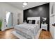 Modern bedroom with a striking black accent wall, wood floors, and a light, airy feel at 2827 Bellaire St, Denver, CO 80207