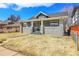 Beautiful craftsman home with a stone facade and inviting front porch, set against a blue sky backdrop at 2827 Bellaire St, Denver, CO 80207