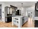 Modern kitchen with a center island, stainless steel appliances, and contrasting dark and white cabinetry at 2827 Bellaire St, Denver, CO 80207