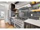 Modern kitchen with professional grade stainless steel appliances, designer backsplash, and hardwood floors at 2827 Bellaire St, Denver, CO 80207